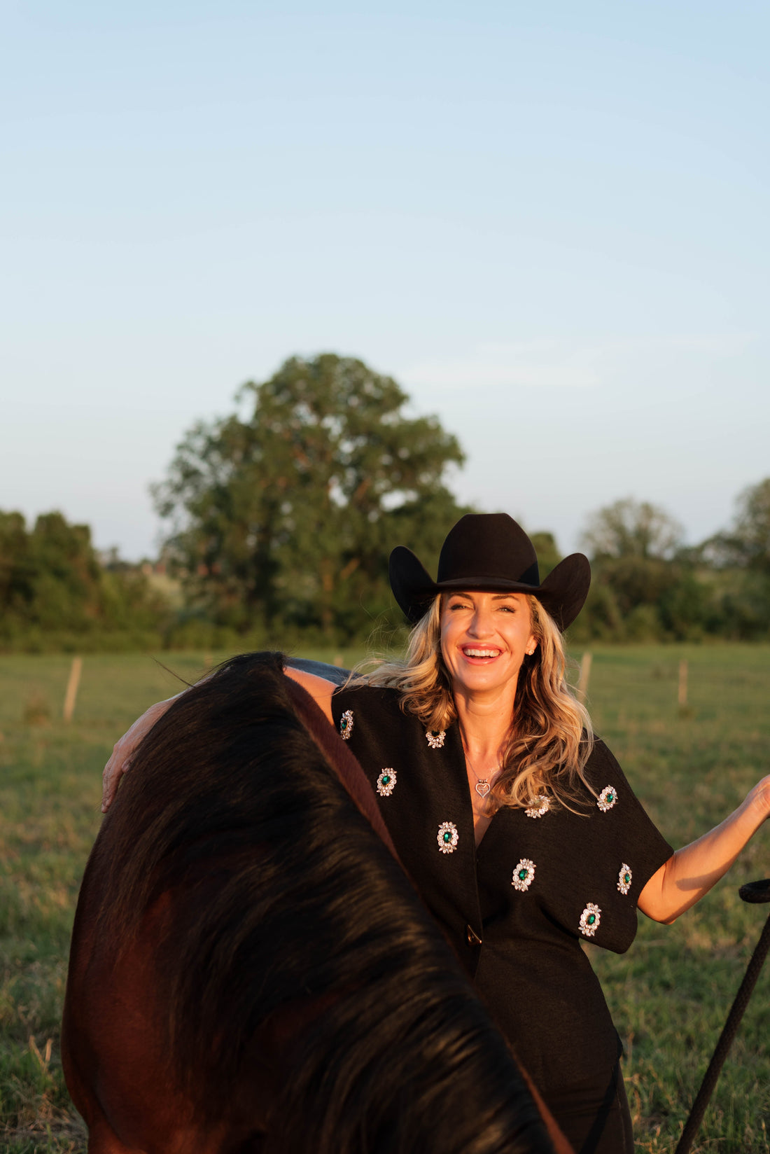 Kate Evans, founder of Highbrow Ranch, with a beginner-safe paint horse in Caldwell, Texas